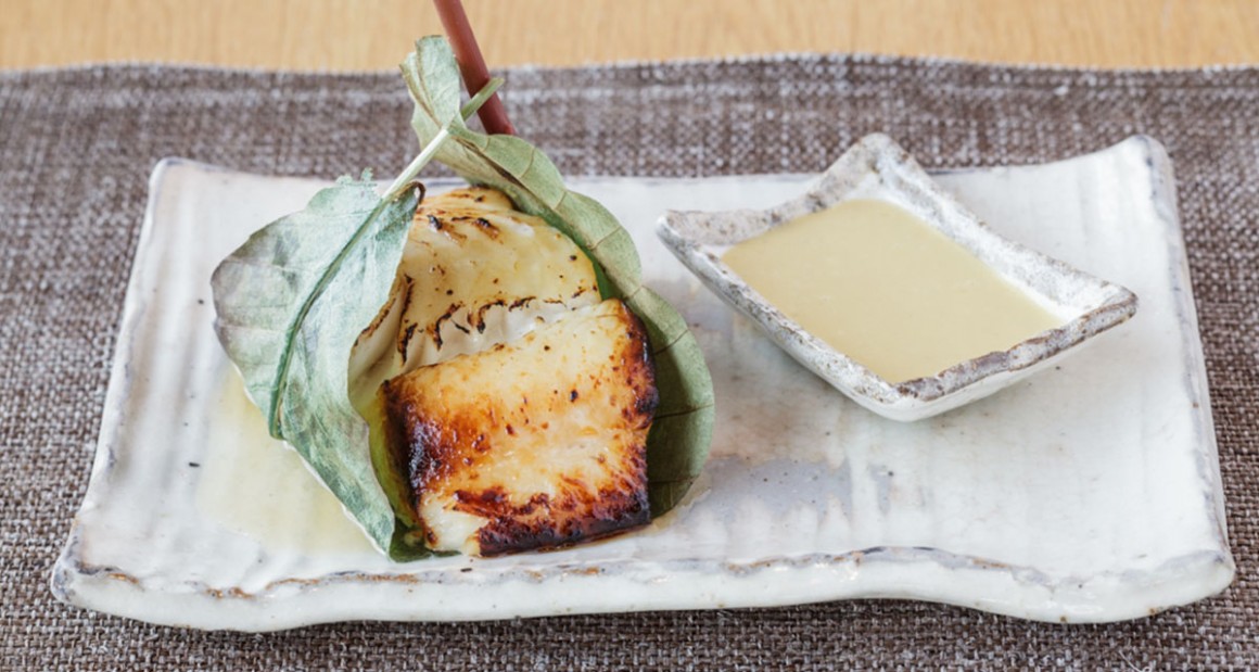 Miso-marinated black cod wrapped in hoba leaf. Photograph by Walter Shintani.